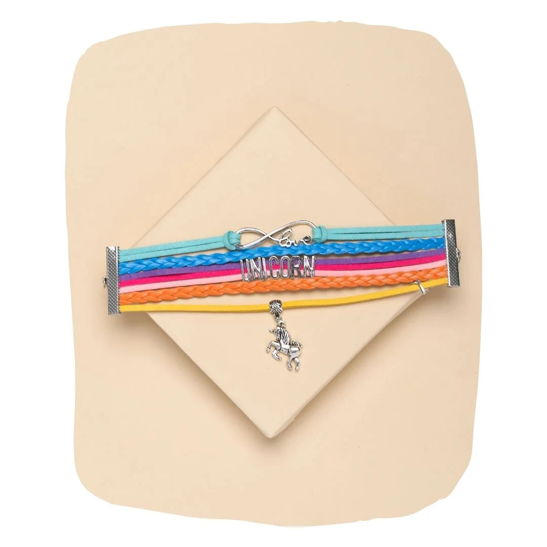Colourful multi-strand leather unicorn charm bracelet with 'love' and 'UNICORN' text, displayed on a neutral background. Adjustable fantasy jewelry for girls aged 3 to 7.