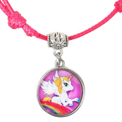 Close-up of unicorn charm on pink faux leather bracelet. Features a white winged unicorn with rainbow background, perfect for kids' fashion.