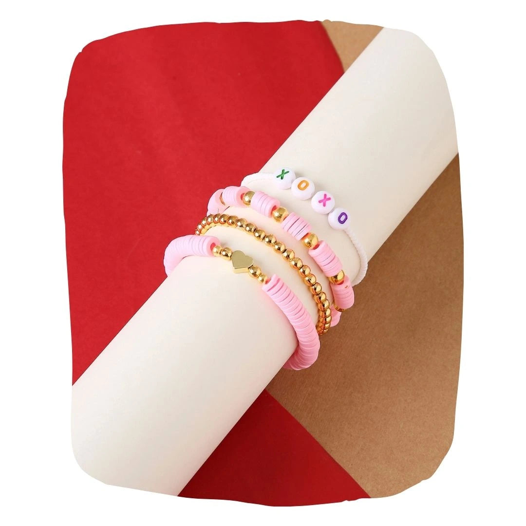 Clay Bead Bracelet Stack - Aesthetic Bliss featuring pink and gold beaded bracelets with heart and XOXO accents, ideal for trendy girls' fashion.