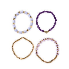 Flat lay of the Lavender Haze Stackable Clay Bead Bracelet Set with four colorful and lightweight boho bracelets in purple and gold tones.