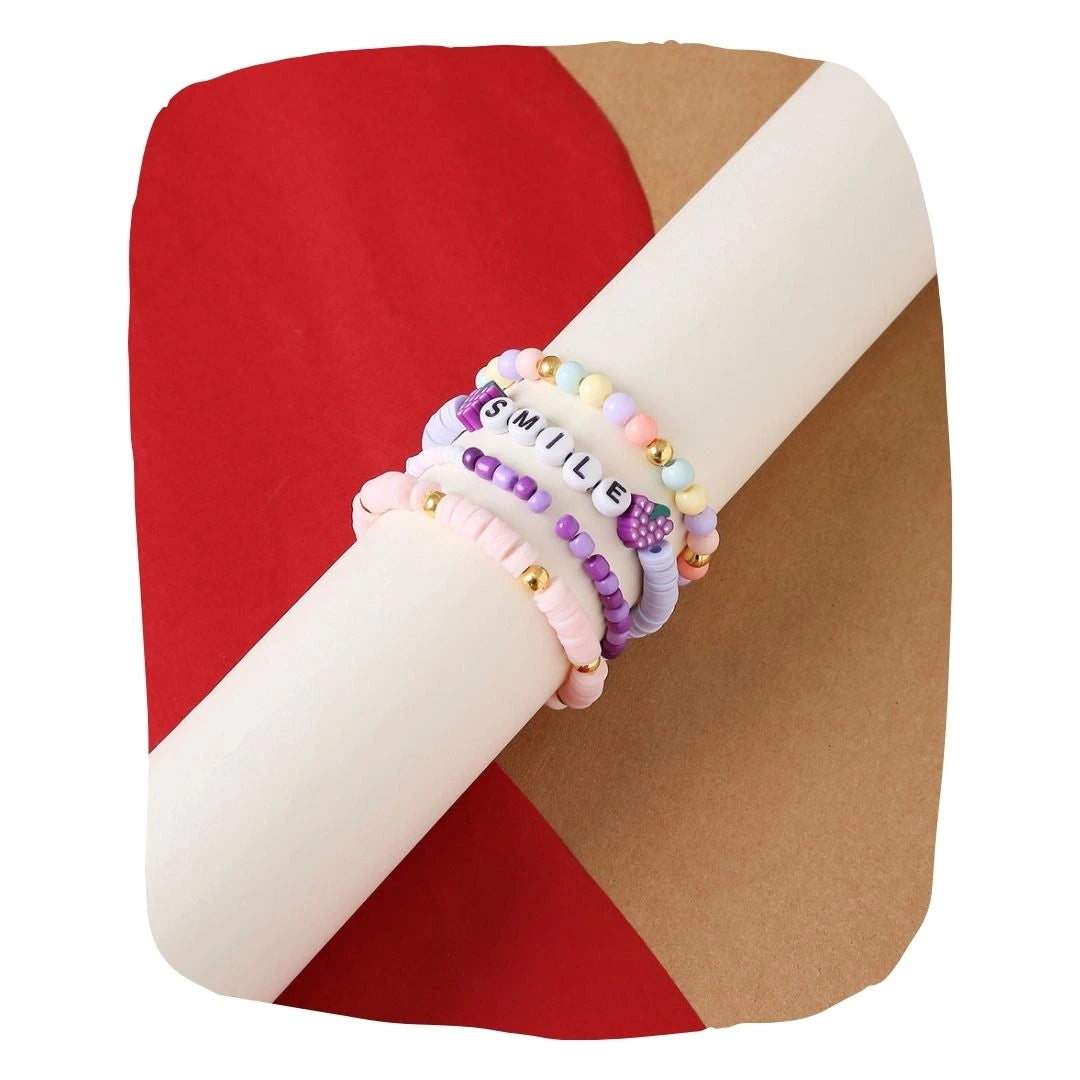 Clay Bead Bracelet Stack Teens - Stretch & Stack featuring pastel and gold-toned stretchy bracelets with 'SMILE' letter beads, ideal for layering.