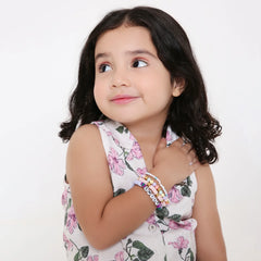 Young girl wearing the Cotton Candy Skies Stretchy Bead Bracelet Stack, showcasing colorful clay bead bracelets perfect for trendy teen fashion.