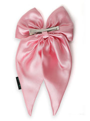 Back view of pink satin hair bow showing secure anti-breakage clip, designed for gentle and firm hold.