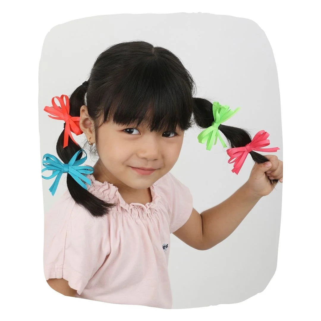 Girl wearing double fold neon hair bows in red, green, pink, and blue with secure alligator clips, ideal for kids aged 3 to 7.