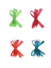 Back view of neon hair bows showing alligator clips for firm grip, ideal for kids' daily wear and special occasions.