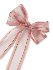 Close-up of pink organza hair bow with shimmering gold edges. Handmade design adds charm to any hairstyle.