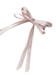 Close-up of blush pink Satin Silk Hair Bow, handmade for women. Features long ribbon tails and soft sheen for elegant hair styling.