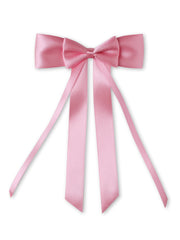 Close-up of pink satin silk ribbon double bow with long tail, ideal for stylish hair accessorizing in girls' fashion collections.