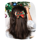 Girl wearing Arendelle's Christmas Hair Bow in festive red and green colors, perfect for holiday outfits and parties.