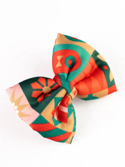 Angled view of Arendelle's Christmas Hair Bow showcasing its colorful geometric holiday design for girls' festive wear.