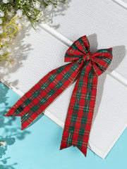 Arendelle Christmas Hair Bow for Girls in red and green checkered pattern with gold trim, displayed on white textured background.