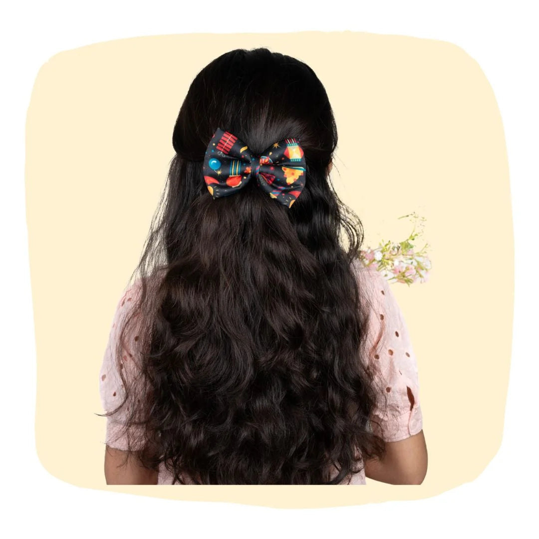 Girl wearing Diwali Fireworks Hair Bow with festive print, perfect for 3 to 12 years. Ideal Diwali hair accessory for girls' celebrations.