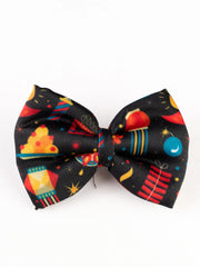 Close-up of Diwali Fireworks Hair Bow featuring colorful rockets and lanterns on black fabric. Trendy festive hair accessory for girls.