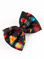 Angled view of Diwali Fireworks Hair Bow showing vibrant Diwali-themed print. Stylish clip for festive girls' hair styling.