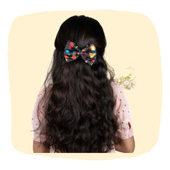 Girl wearing Diwali Fireworks Hair Bow with festive print, perfect for 3 to 12 years. Ideal Diwali hair accessory for girls' celebrations.
