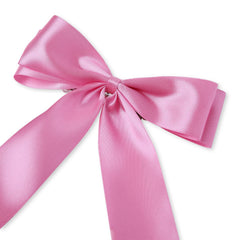 Close-up of pink satin bridesmaid bow with smooth finish, ideal for elegant wedding hairstyles. Reusable and versatile hair clip.