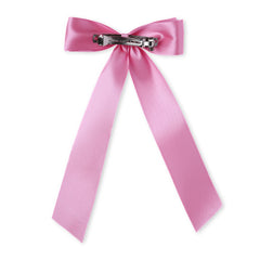 Back view of pink satin hair bow with metal clip, designed for secure wear during weddings and events.