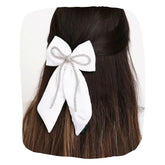 White Rhinestone Hair Bow clipped on long dark hair, showcasing elegant velvet texture and secure hold for stylish everyday wear.