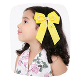 Girl wearing yellow Pearl Beaded Hair Bow with grosgrain ribbon, ideal for colorful and secure kids' hairstyles.