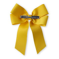 Back view of yellow Pearl Beaded Hair Bow with secure metal clip, designed for firm hold in children's hairstyles.