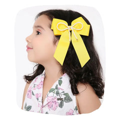 Girl wearing yellow Pearl Beaded Hair Bow with grosgrain ribbon, ideal for colorful and secure kids' hairstyles.