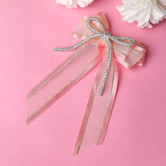 Shiny Organza Hair Bow in rose pink with rhinestone cord on a pink background, ideal gift accessory for kids and women.