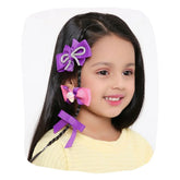Girl wearing Pink Purple Hair Bows Combo featuring handmade clips with glitter and ice cream embellishment, ideal for stylish hairstyles.