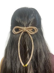 Champagne gold rhinestone hair bow for girls, crafted with a double-layered long tail cord for a chic and comfortable hair accessory.