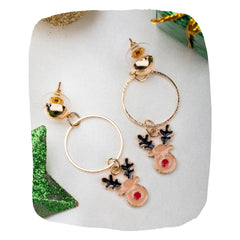 Rudolph Reindeer Earrings with gold hoops and red-nosed charms on white fabric, festive Christmas jewelry for girls and women.