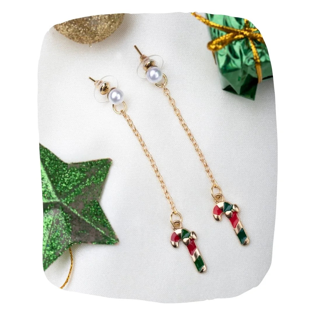 Christmas Special Candy Cane Drop Earrings | Arendelle featuring red and green enamel charms on gold chains, styled with festive decorations.