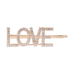 Front view of trendy kids gold 'LOVE' hairpin with sparkling rhinestones. Fun and fashionable hair accessory for young girls.