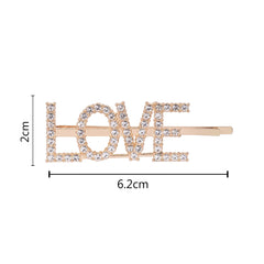 Gold 'LOVE' hairpin with rhinestones, measuring 6.2cm by 2cm. Perfect size for girls' hair, combining style and comfort.