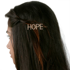 Gold Glitter HOPE Hairpin worn on dark hair, showcasing trendy clip design perfect for girls and teens in casual or party looks.
