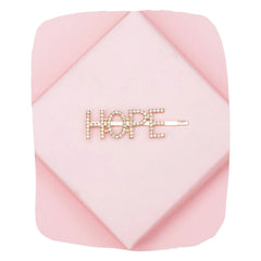 Gold Glitter HOPE Hairpin on pink background, featuring sparkling rhinestones in bold lettering for stylish hair accessory appeal.