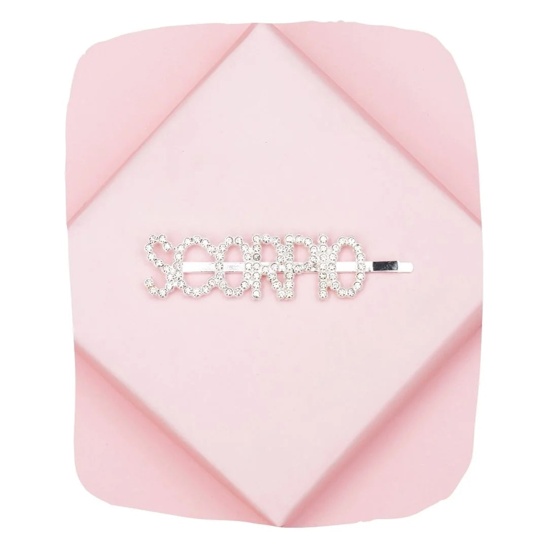 Scorpio Zodiac Hairpin with sparkling rhinestones on a pink geometric background, perfect astrology accessory for stylish hair looks.