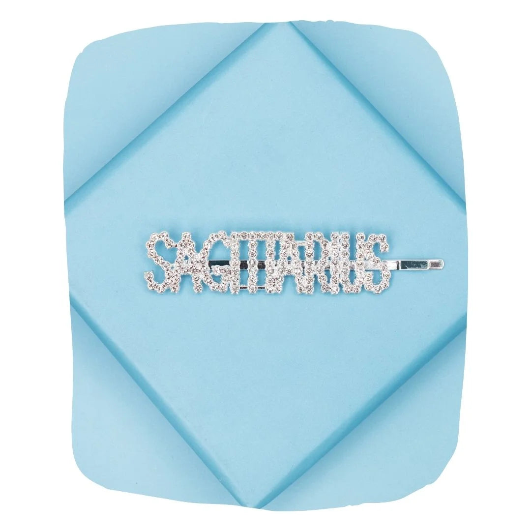 Sagittarius rhinestone hairpin on blue background, featuring sparkling crystals and secure grip for zodiac-themed hair styling.
