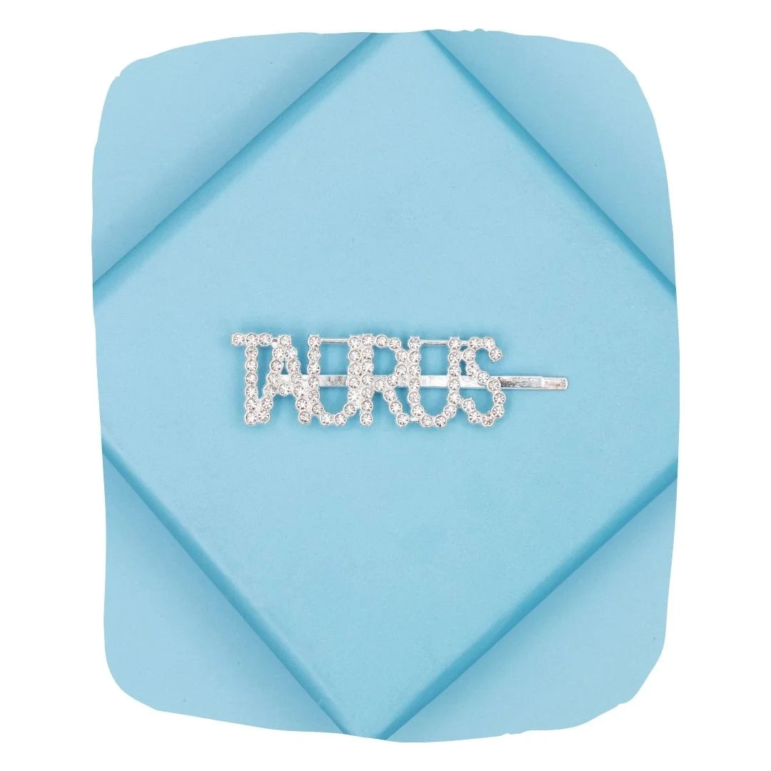 Taurus Zodiac Hairpin with sparkling rhinestones displayed on a folded blue background, ideal for astrology-themed hair accessories.