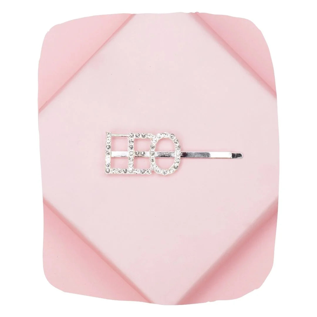 LEO Zodiac Hairpin with rhinestone lettering on a pink geometric background. Elegant design for astrology-themed hair accessories.