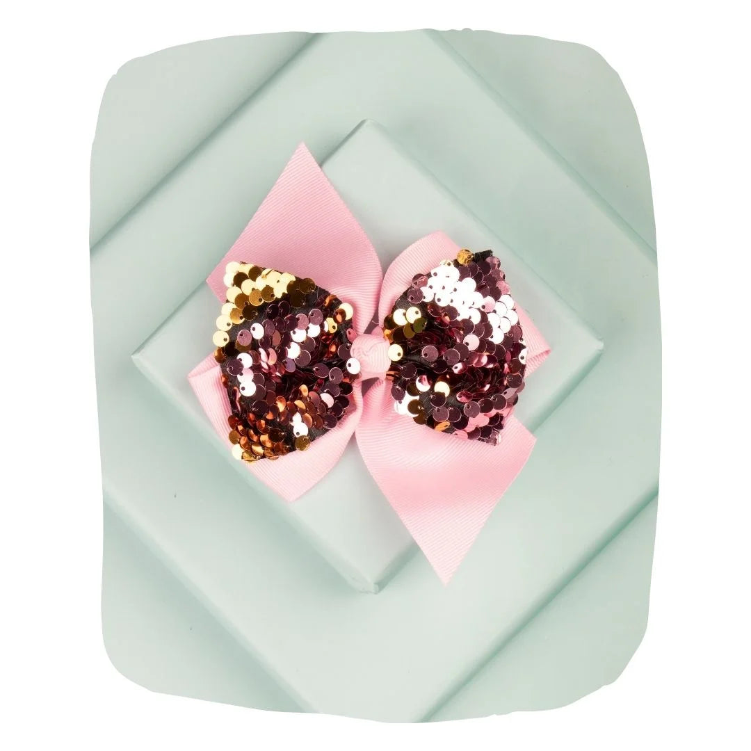 Arendelle baby pink hair bow with shiny sequins displayed on a pastel background. Perfect for girls aged 3 to 7 for stylish hair accessorizing.