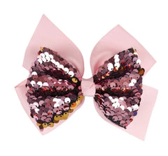 Front view of Arendelle baby pink sequin hair bow for girls. Stylish and comfortable accessory for ages 3 to 7.