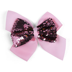 Close-up of Arendelle baby pink hair bow featuring glossy pink and gold sequins. A fashionable hair accessory for young girls.
