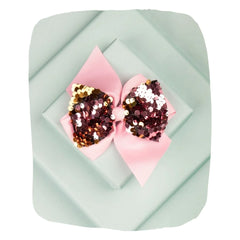 Arendelle baby pink hair bow with shiny sequins displayed on a pastel background. Perfect for girls aged 3 to 7 for stylish hair accessorizing.