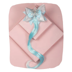 Arendelle Ice Blue Hair Bow for Girls with glittery silver accents and snowflake charm, styled with long blue extensions on pink background.