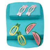 Trendy kids hair clips set featuring kitty, pineapple, and watermelon designs on a turquoise background. Fun and colorful hair pins for girls aged 3 to 7.