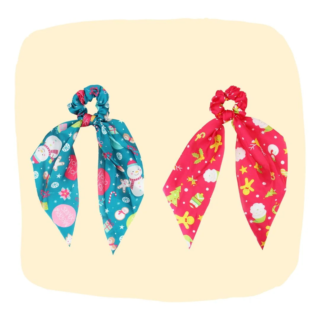 Arendelle Christmas Hair Scrunchies for Girls in festive blue and red satin with snowman, reindeer, and holiday prints. Ideal for holiday outfits.