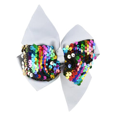 Close-up of stylish grey bow pin adorned with vibrant sequins, perfect for adding sparkle to girls' outfits.