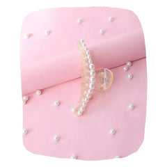 Elegant Pearl Hair Claw Clip with soft grip, styled on pink background with scattered pearls. Ideal hair accessory for girls aged 3 to 7.