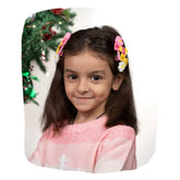 Girl wearing Pompom Flower Hair Clips Set in yellow and pink, styled for festive or party look. Ideal hair accessories for girls aged 3-10.