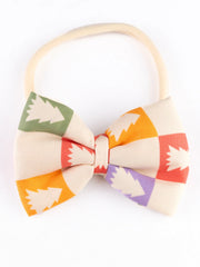 Close-up of Yellow Bow Baby Headband featuring colorful Christmas tree pattern, ideal for infants and toddlers' festive wear.