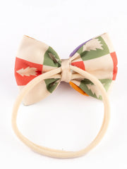 Back view of Yellow Bow Baby Headband showing soft elastic band and pastel holiday-themed bow for comfortable toddler wear.